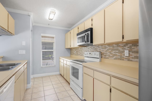 1227 Tuxford Dr, Brandon, FL 33511 - kitchen with white appliances, a textured ceiling, decorative backsplash, and cream cabinets