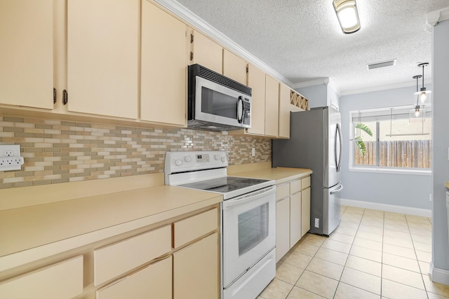 1227 Tuxford Dr, Brandon, FL 33511 - kitchen featuring cream cabinets, stainless steel appliances, visible vents, and light countertops
