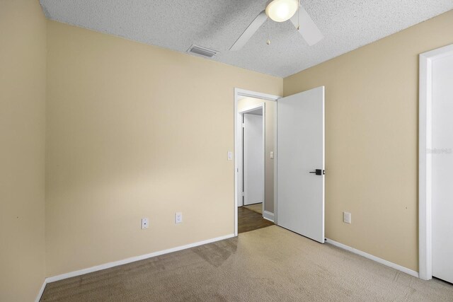 1227 Tuxford Dr, Brandon, FL 33511 - unfurnished bedroom featuring carpet floors, visible vents, baseboards, ceiling fan, and a textured ceiling