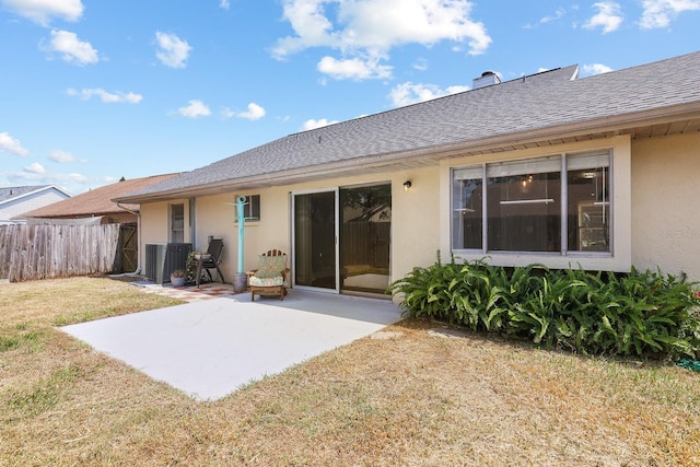 1227 Tuxford Dr, Brandon, FL 33511 - back of house featuring fence, a patio, stucco siding, and a lawn