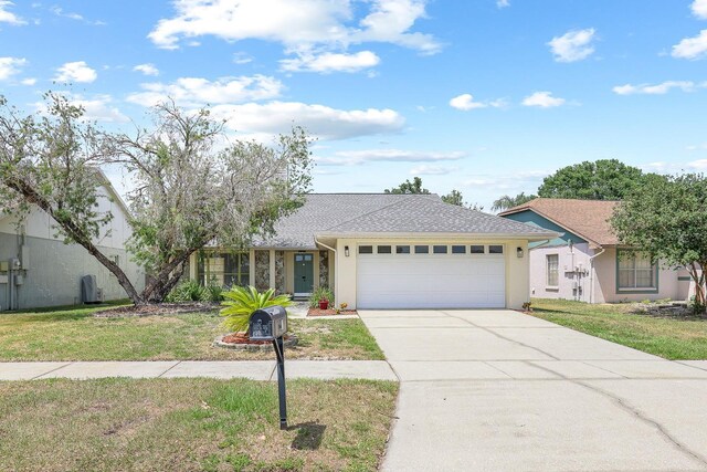 1227 Tuxford Dr, Brandon, FL 33511 - ranch-style home featuring a garage, a front lawn, stucco siding, and driveway