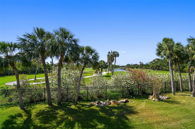 view of yard featuring fence and a water view