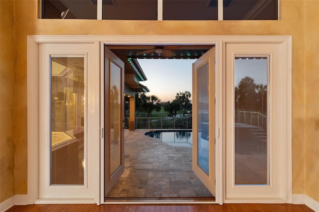 doorway featuring baseboards
