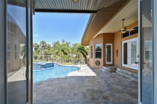 view of swimming pool with french doors, a ceiling fan, a patio, and a pool with connected hot tub