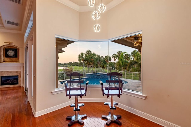 dining room featuring baseboards, ornamental molding, hardwood / wood-style floors, and visible vents