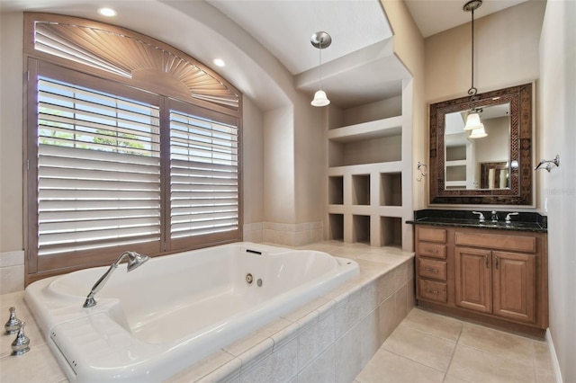 bathroom featuring vanity, tile patterned flooring, and a whirlpool tub