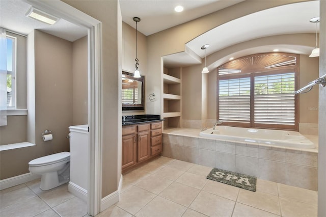 full bath with vanity, built in features, toilet, a bath, and tile patterned floors