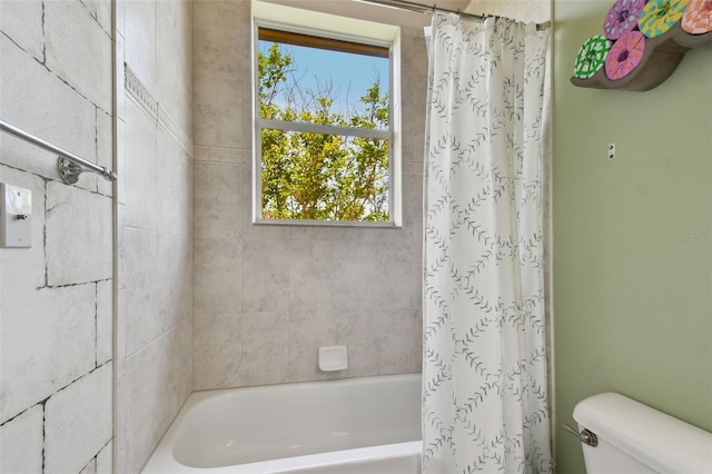 bathroom with toilet and shower / bath combination with curtain
