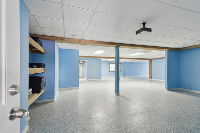 finished below grade area featuring baseboards and a drop ceiling