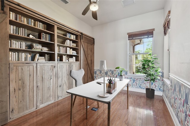 2605 59th St S, Gulfport, FL 33707 - home office with a ceiling fan, wallpapered walls, baseboards, visible vents, and hardwood / wood-style flooring