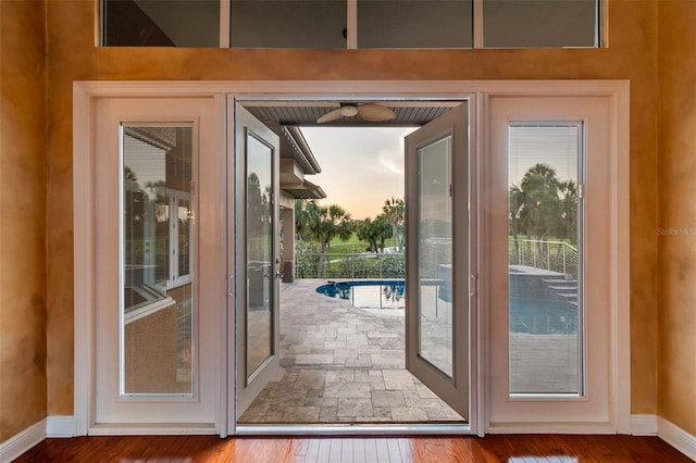2605 59th St S, Gulfport, FL 33707 - doorway to outside with hardwood / wood-style flooring, baseboards, a ceiling fan, and a healthy amount of sunlight