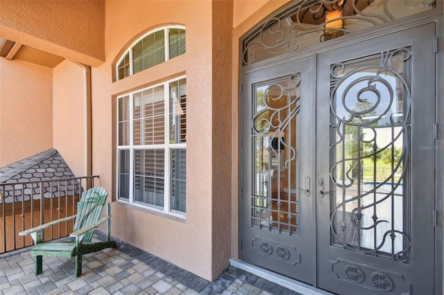 2605 59th St S, Gulfport, FL 33707 - doorway to property featuring stucco siding and french doors