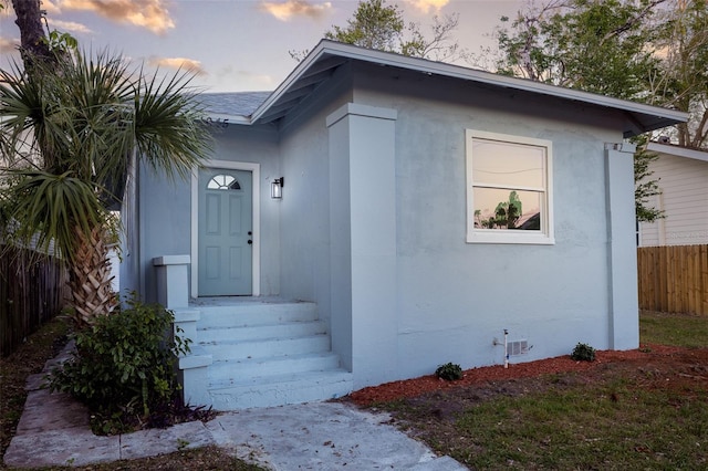 1045 22nd Ave N, Saint Petersburg, FL 33704 - view of exterior entry with stucco siding and fence