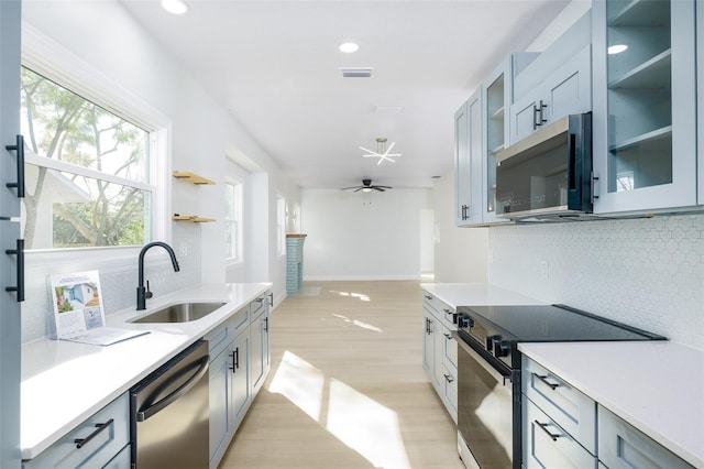 1045 22nd Ave N, Saint Petersburg, FL 33704 - kitchen featuring a sink, light countertops, backsplash, and stainless steel appliances