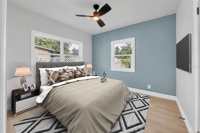 1045 22nd Ave N, Saint Petersburg, FL 33704 - bedroom with baseboards, a ceiling fan, and wood finished floors