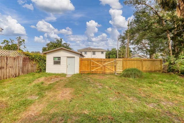 1045 22nd Ave N, Saint Petersburg, FL 33704 - view of yard featuring an outbuilding, a gate, and a fenced backyard