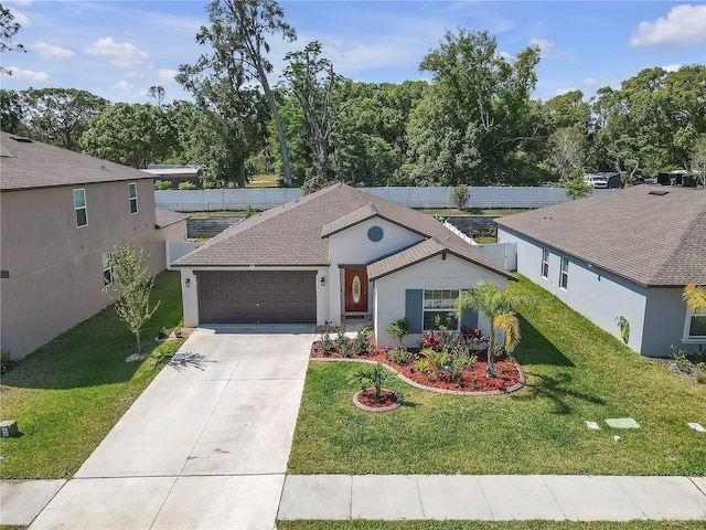 single story home with driveway, a front yard, a garage, fence, and stucco siding