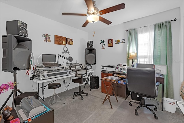 carpeted office space with ceiling fan