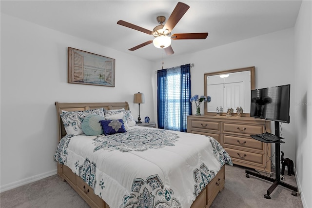 bedroom with baseboards, ceiling fan, and light carpet