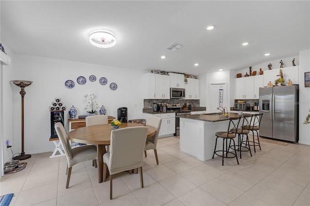 dining area featuring light tile patterned floors, recessed lighting, and visible vents