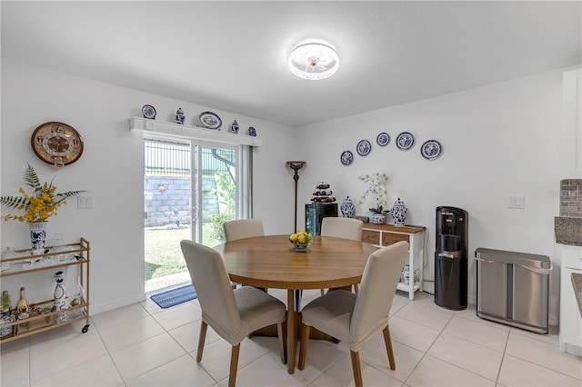 dining area with baseboards and light tile patterned floors