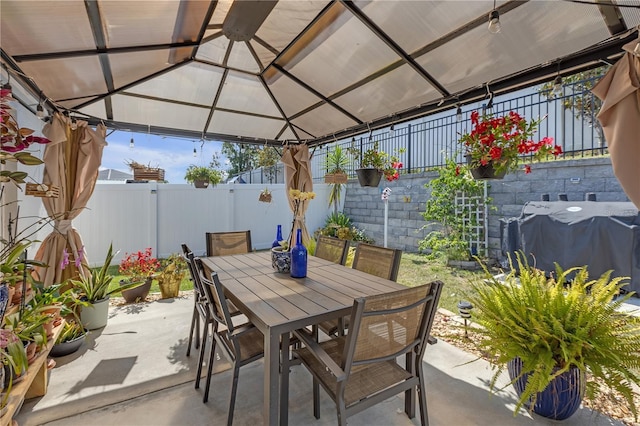 view of patio with a fenced backyard, outdoor dining space, a gazebo, and a grill