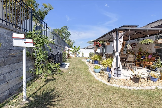 view of yard with a gazebo, fence, and a patio area