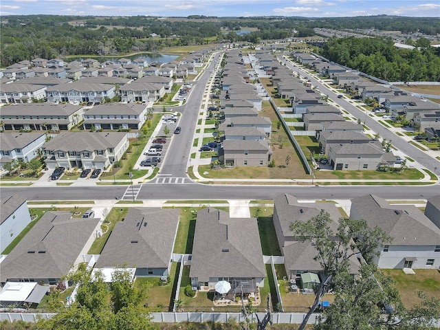 drone / aerial view featuring a water view and a residential view