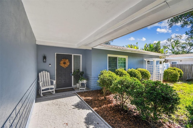 13749 80th Ave, Seminole, FL 33776 - entrance to property featuring stucco siding and fence
