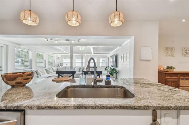 13749 80th Ave, Seminole, FL 33776 - kitchen featuring a sink, light stone countertops, pendant lighting, and open floor plan