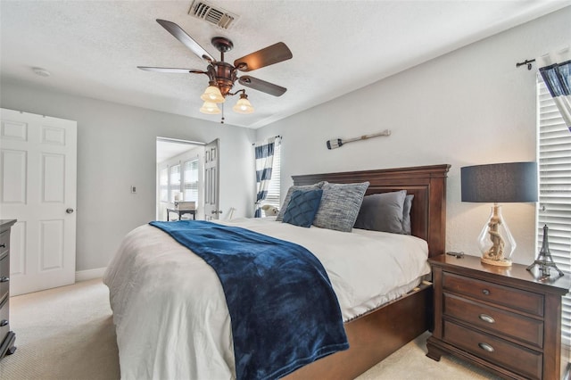 13749 80th Ave, Seminole, FL 33776 - bedroom featuring baseboards, ceiling fan, light colored carpet, and visible vents