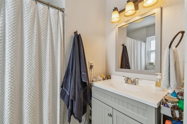 13749 80th Ave, Seminole, FL 33776 - full bath with vanity, a textured wall, and curtained shower