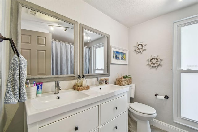 13749 80th Ave, Seminole, FL 33776 - full bathroom featuring visible vents, a sink, double vanity, and toilet