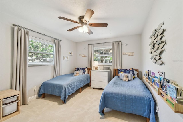 13749 80th Ave, Seminole, FL 33776 - bedroom featuring multiple windows, a ceiling fan, and light colored carpet