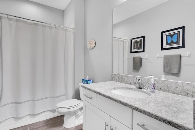 full bath with vanity, toilet, and wood finished floors