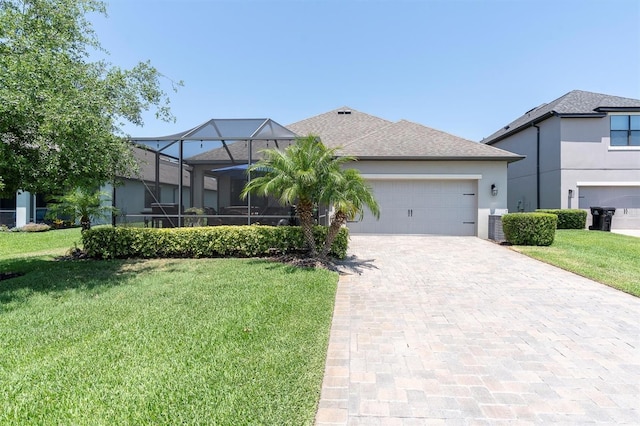view of front of house with an attached garage, decorative driveway, stucco siding, and a front yard