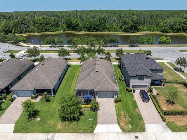 birds eye view of property with a water view and a wooded view