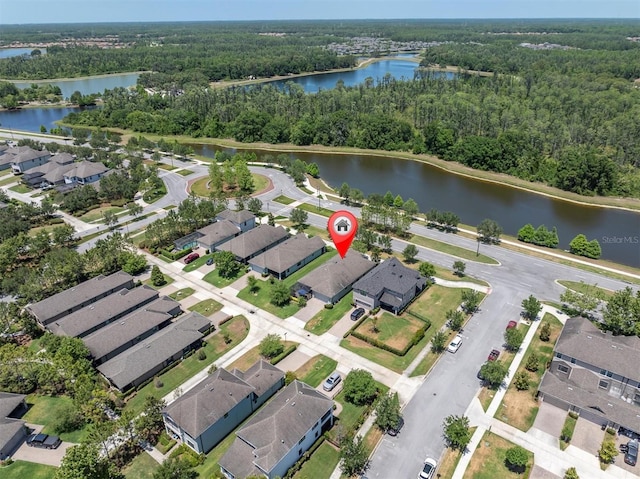 aerial view with a water view, a residential view, and a forest view