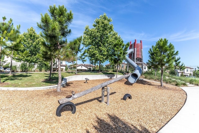 view of property's community featuring a yard and playground community
