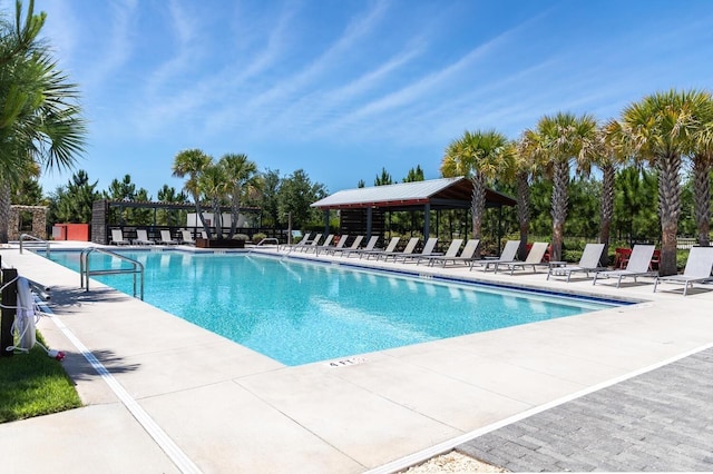 community pool with a gazebo and a patio area