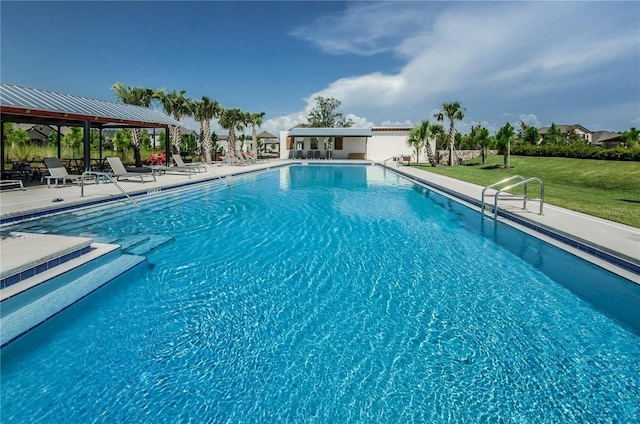 pool with a patio, a gazebo, and a yard