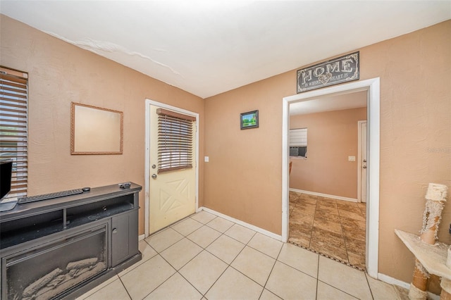 interior space featuring baseboards and light tile patterned floors