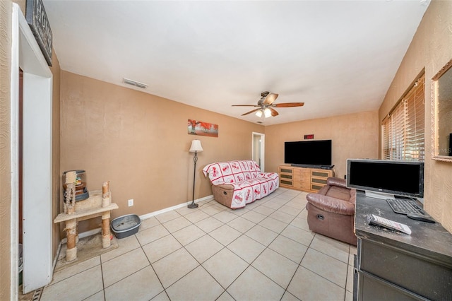 living area with a ceiling fan, light tile patterned flooring, and visible vents