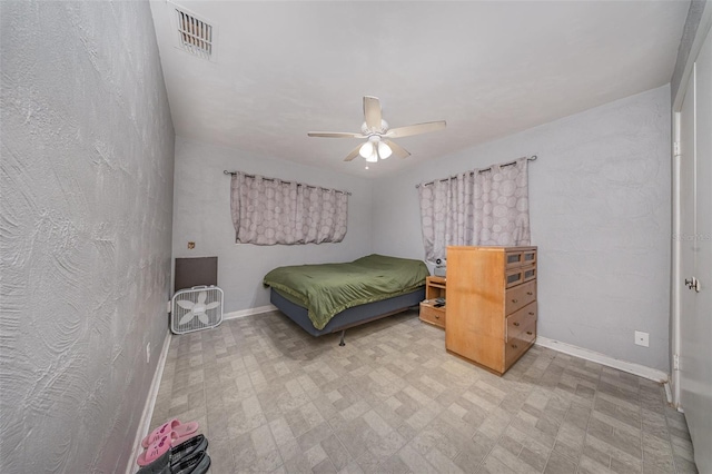 bedroom with visible vents, baseboards, and ceiling fan