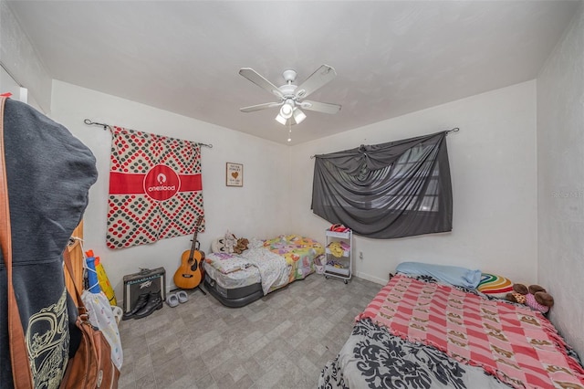 bedroom with a ceiling fan and tile patterned floors