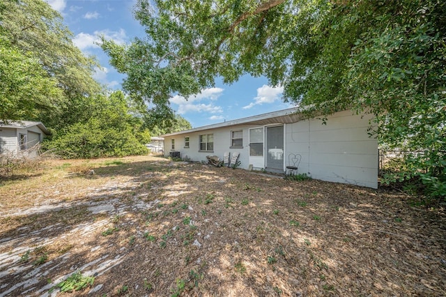 back of house with fence