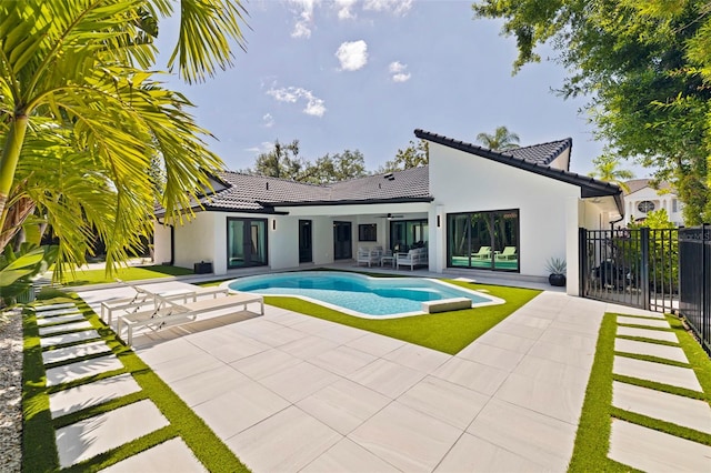 outdoor pool featuring a ceiling fan, a patio area, and fence