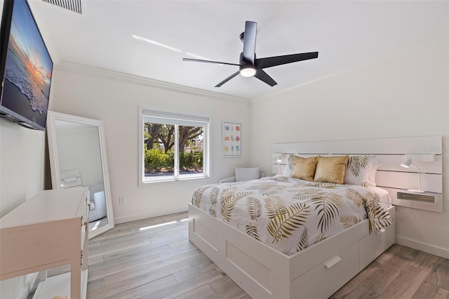 bedroom featuring crown molding, baseboards, and light wood-style floors
