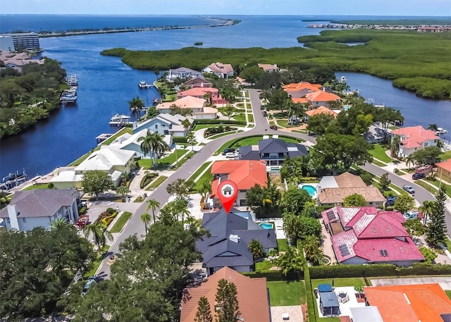 drone / aerial view with a residential view and a water view
