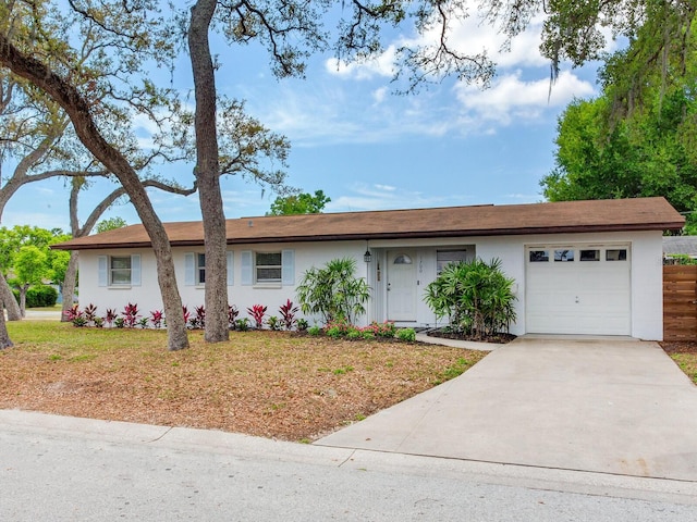 1700 25th St N, Saint Petersburg, FL 33713 - single story home with an attached garage, concrete driveway, and stucco siding